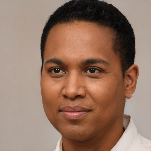 Joyful black young-adult male with short  brown hair and brown eyes