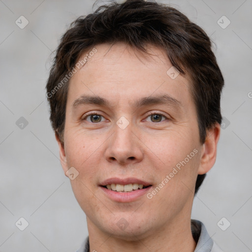 Joyful white adult male with short  brown hair and brown eyes