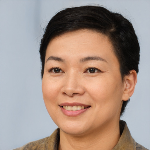Joyful asian young-adult female with short  brown hair and brown eyes