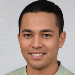 Joyful white young-adult male with short  black hair and brown eyes