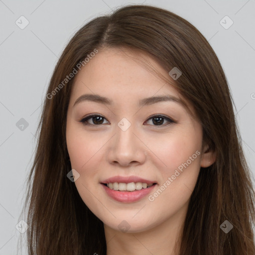 Joyful asian young-adult female with long  brown hair and brown eyes