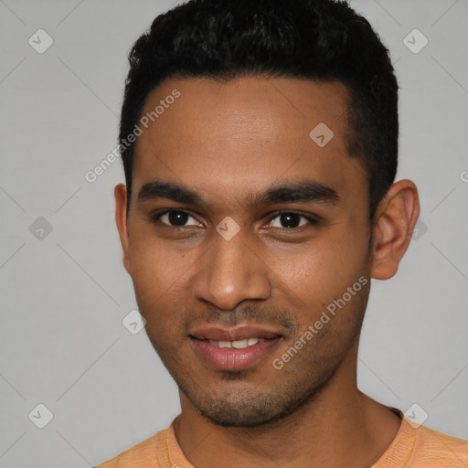 Joyful black young-adult male with short  black hair and brown eyes