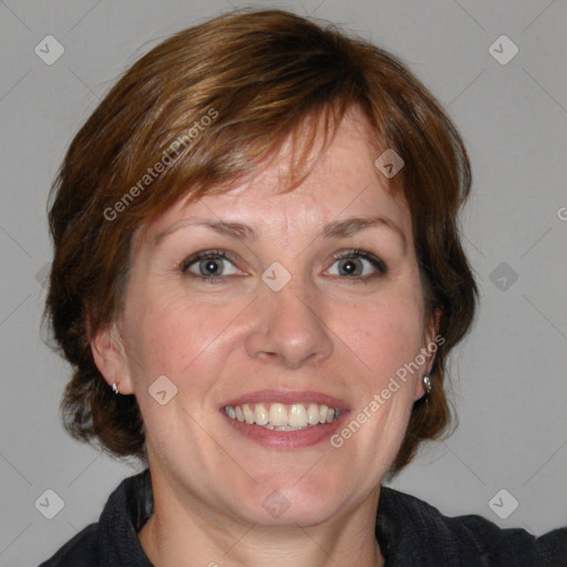 Joyful white adult female with medium  brown hair and blue eyes