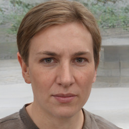 Joyful white adult female with short  brown hair and grey eyes