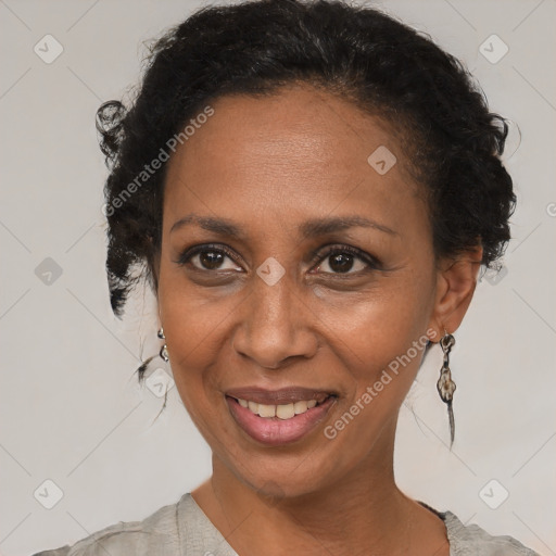 Joyful black adult female with short  brown hair and brown eyes