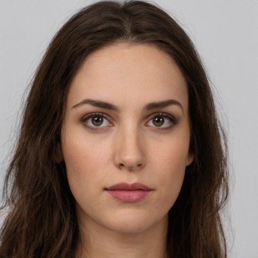 Neutral white young-adult female with long  brown hair and brown eyes