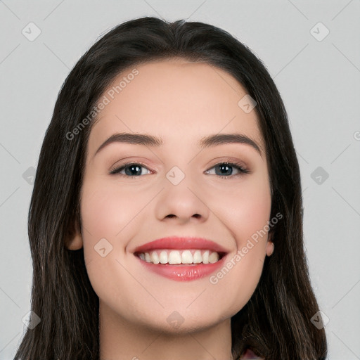 Joyful white young-adult female with long  black hair and brown eyes