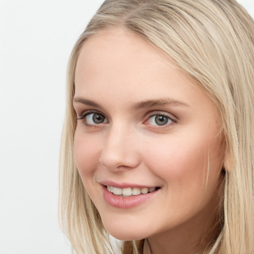 Joyful white young-adult female with long  brown hair and blue eyes