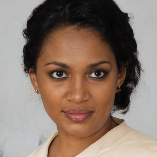 Joyful black young-adult female with short  brown hair and brown eyes