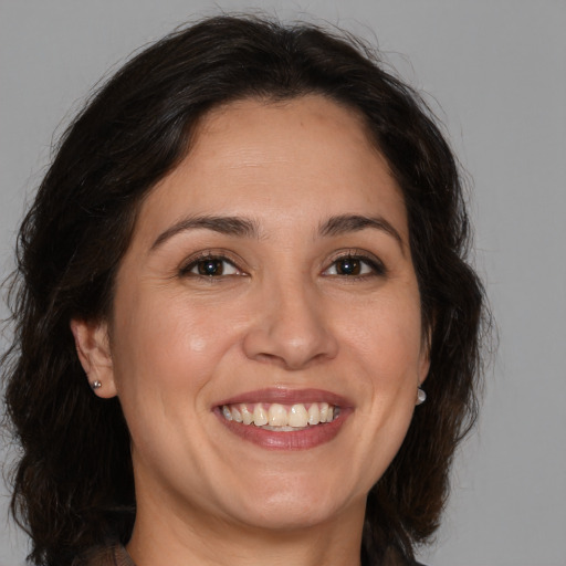 Joyful white adult female with medium  brown hair and brown eyes