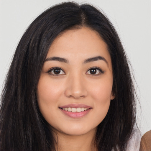 Joyful asian young-adult female with long  brown hair and brown eyes