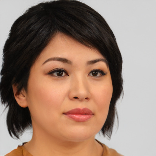 Joyful asian young-adult female with medium  black hair and brown eyes