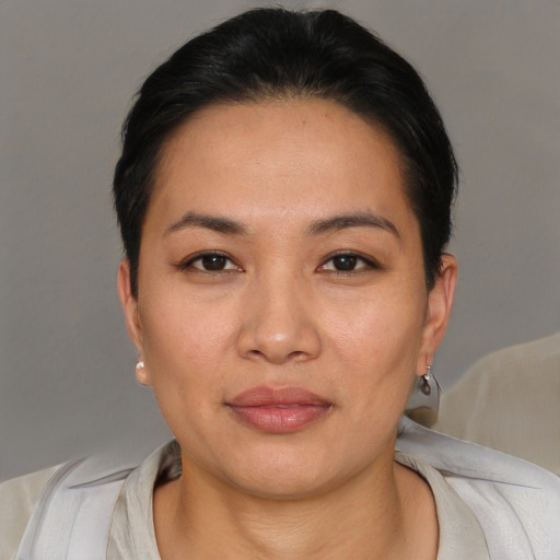 Joyful asian young-adult female with short  brown hair and brown eyes