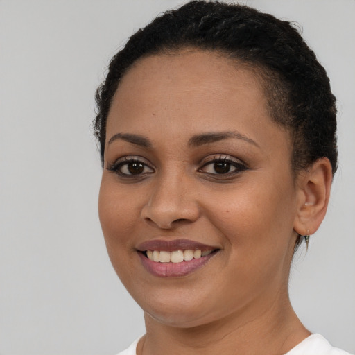 Joyful latino young-adult female with short  brown hair and brown eyes