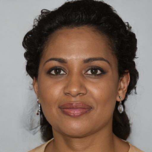 Joyful black young-adult female with medium  brown hair and brown eyes