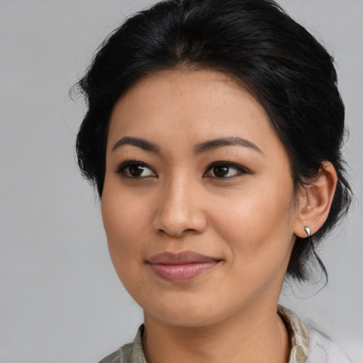 Joyful latino young-adult female with medium  black hair and brown eyes