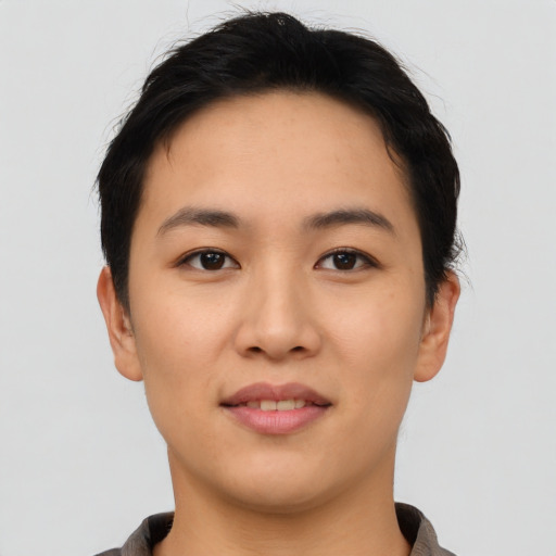 Joyful asian young-adult female with short  black hair and brown eyes