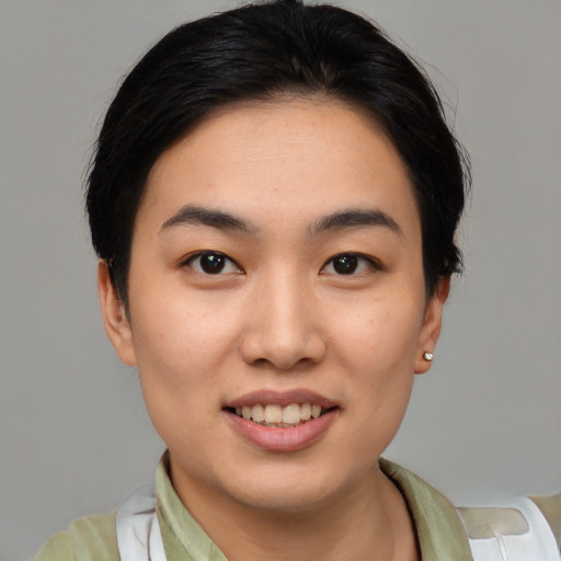 Joyful white young-adult female with short  black hair and brown eyes