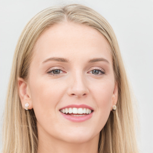 Joyful white young-adult female with long  brown hair and blue eyes