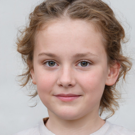 Joyful white child female with medium  brown hair and blue eyes