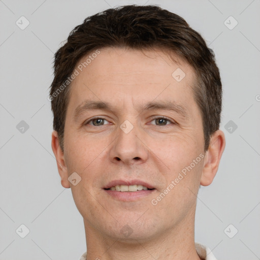 Joyful white adult male with short  brown hair and brown eyes