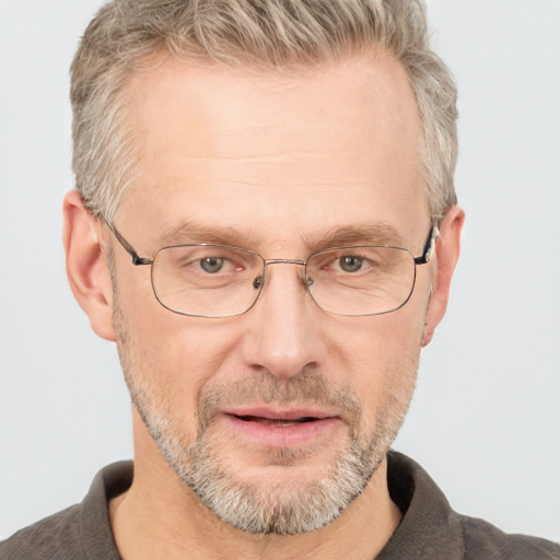 Joyful white middle-aged male with short  brown hair and blue eyes