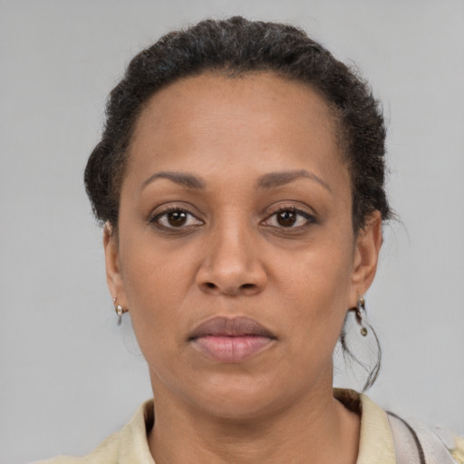 Joyful black adult female with short  brown hair and brown eyes