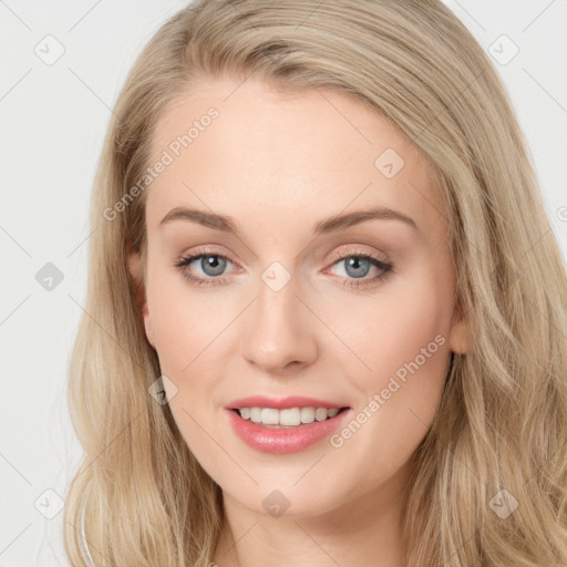 Joyful white young-adult female with long  brown hair and blue eyes