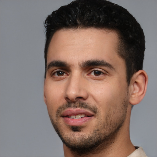 Joyful white young-adult male with short  black hair and brown eyes