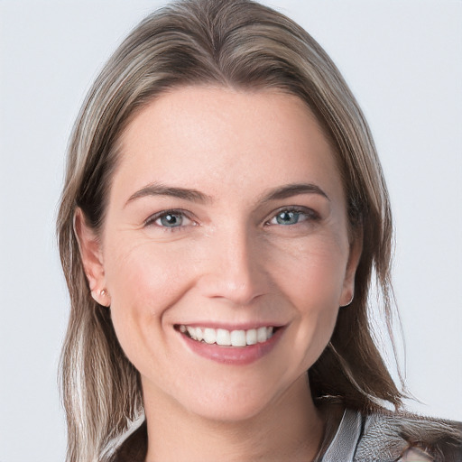 Joyful white young-adult female with long  brown hair and blue eyes