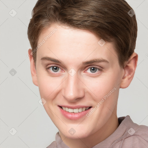 Joyful white young-adult female with short  brown hair and grey eyes