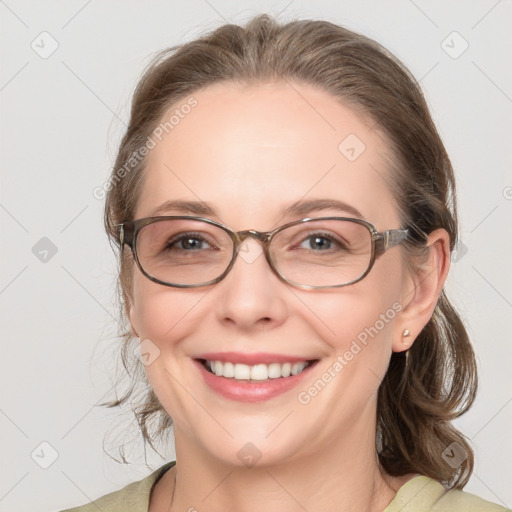 Joyful white adult female with medium  brown hair and grey eyes