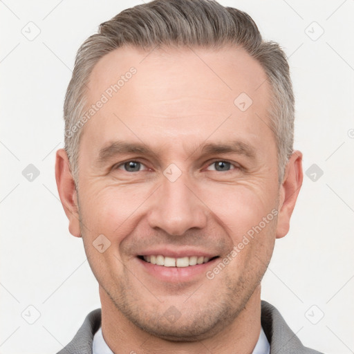 Joyful white adult male with short  brown hair and grey eyes