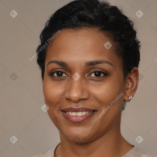 Joyful black young-adult female with short  brown hair and brown eyes