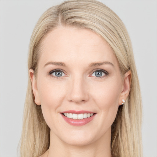 Joyful white young-adult female with long  brown hair and blue eyes