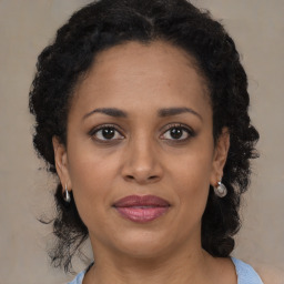 Joyful black adult female with medium  brown hair and brown eyes