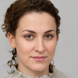 Joyful white young-adult female with medium  brown hair and green eyes