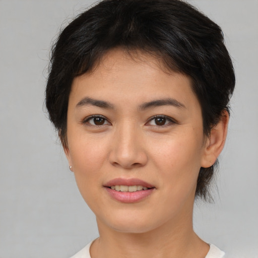 Joyful asian young-adult female with short  brown hair and brown eyes