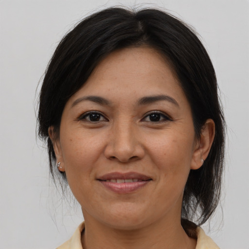 Joyful asian adult female with medium  brown hair and brown eyes