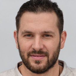 Joyful white adult male with short  brown hair and brown eyes