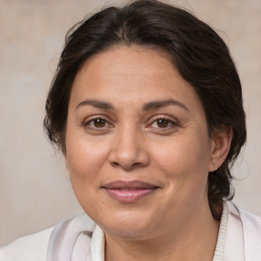 Joyful white adult female with medium  brown hair and brown eyes