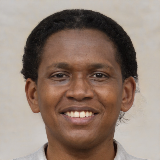 Joyful latino adult male with short  black hair and brown eyes