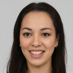 Joyful latino young-adult female with long  brown hair and brown eyes