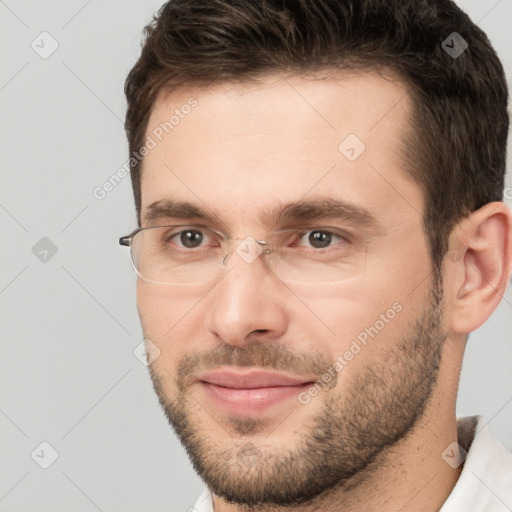 Joyful white young-adult male with short  brown hair and brown eyes