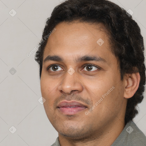 Joyful latino young-adult male with short  brown hair and brown eyes