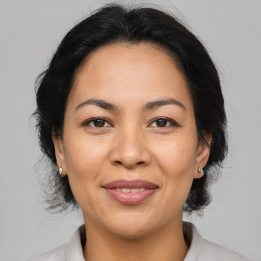 Joyful asian adult female with medium  brown hair and brown eyes