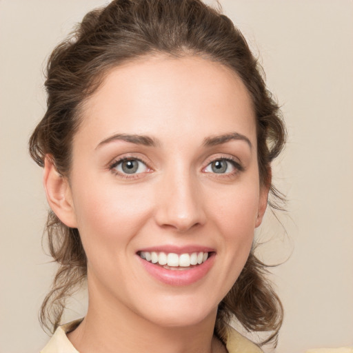 Joyful white young-adult female with medium  brown hair and green eyes