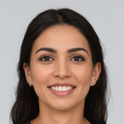 Joyful latino young-adult female with long  brown hair and brown eyes