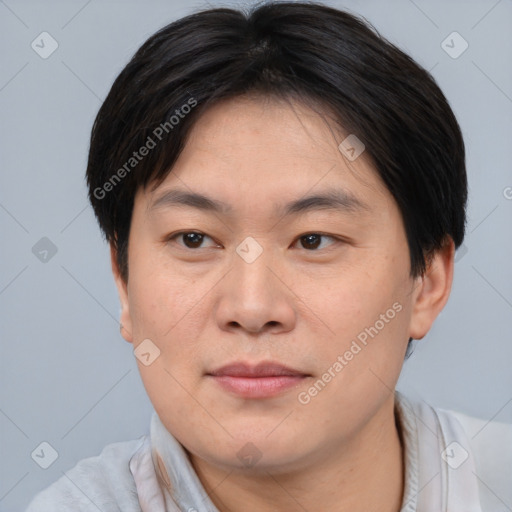 Joyful asian young-adult male with short  brown hair and brown eyes