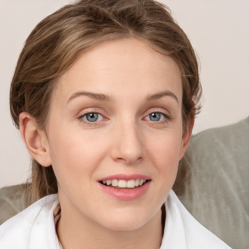 Joyful white young-adult female with medium  brown hair and blue eyes